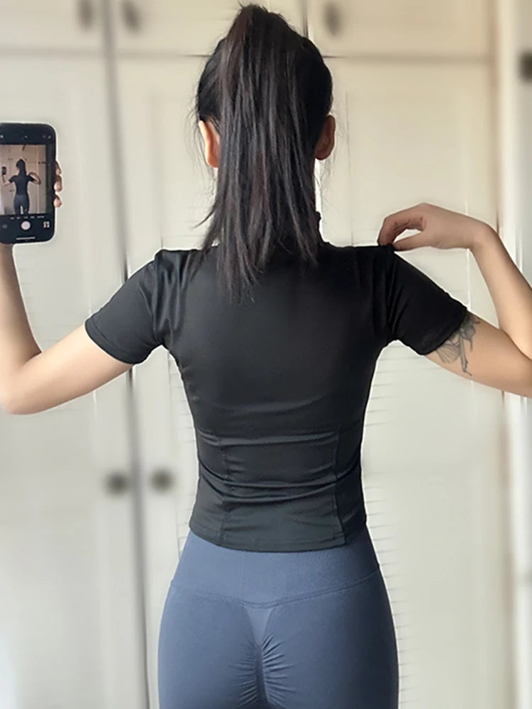 Back view of a woman wearing a black women's summer waist slimming yoga top for comfortable workouts