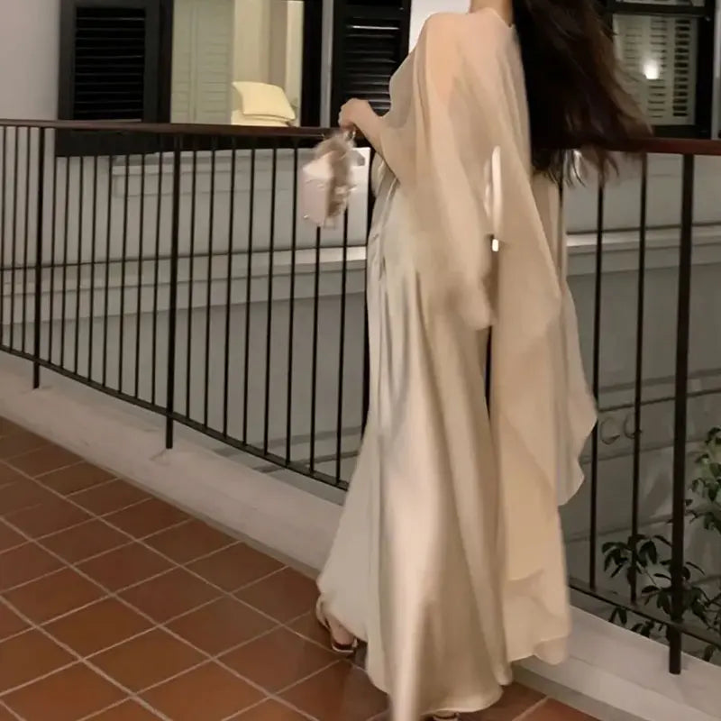 Elegant vintage chiffon evening cape for women draped over a stylish outfit on a balcony