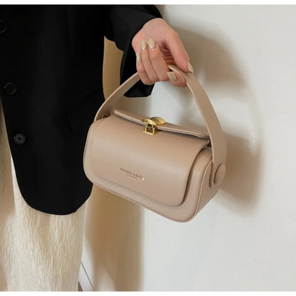 Stylish woman's hand holding a Women's Classic Versatile Retro Square Bag in beige, perfect for various outfits