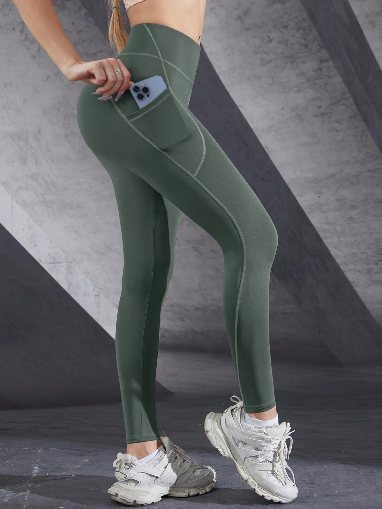 VaultHaus women's leggings with pockets in green, featuring a side pocket for convenience