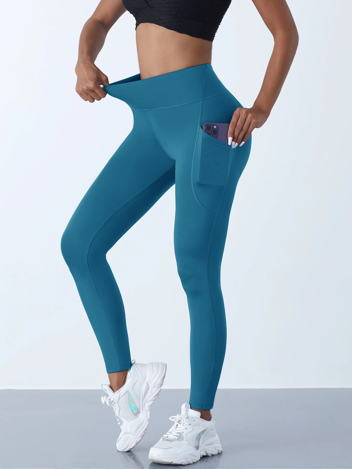 Teal women's leggings with pockets designed for comfort and style during workouts