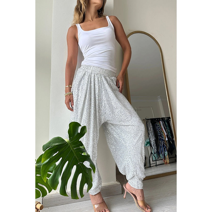 Stylish women's sequin harem pants in silver with a relaxed fit and lightweight fabric for comfortable wear