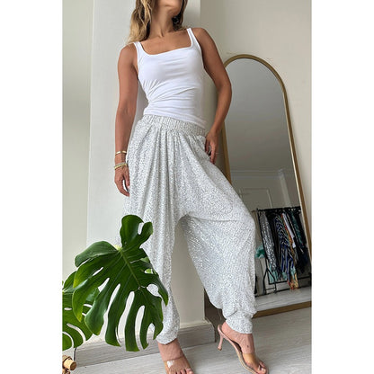 Stylish women's sequin harem pants in silver with a relaxed fit and lightweight fabric for comfortable wear
