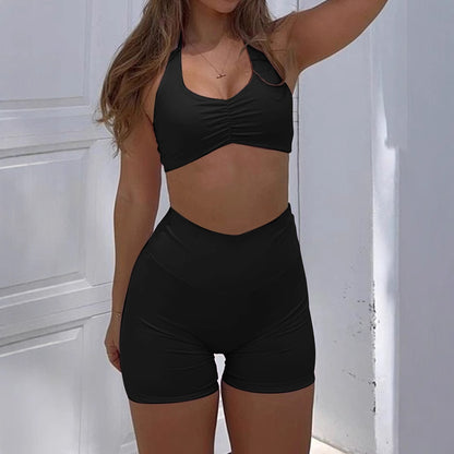 Stylish black women's sportswear set featuring a cropped top and high-waisted shorts
